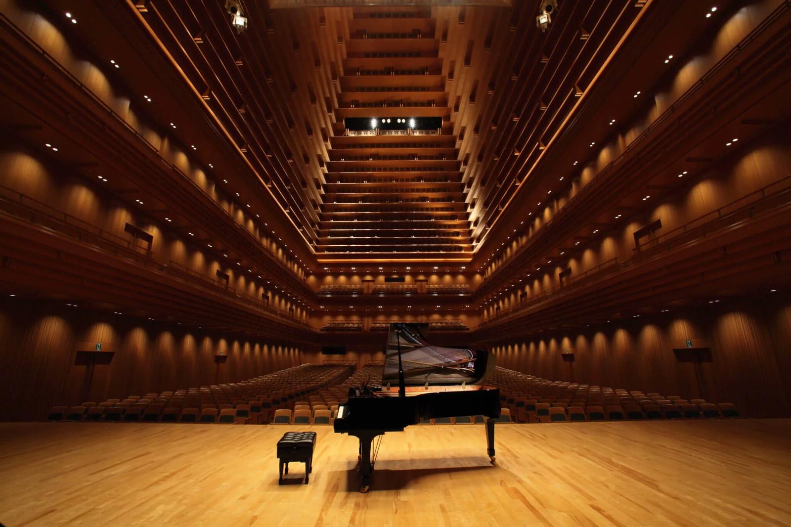 A grand piano on a concert hall stage